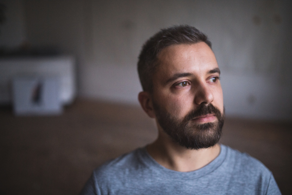 Portrait of a handsome man at home or in an office. Close up.