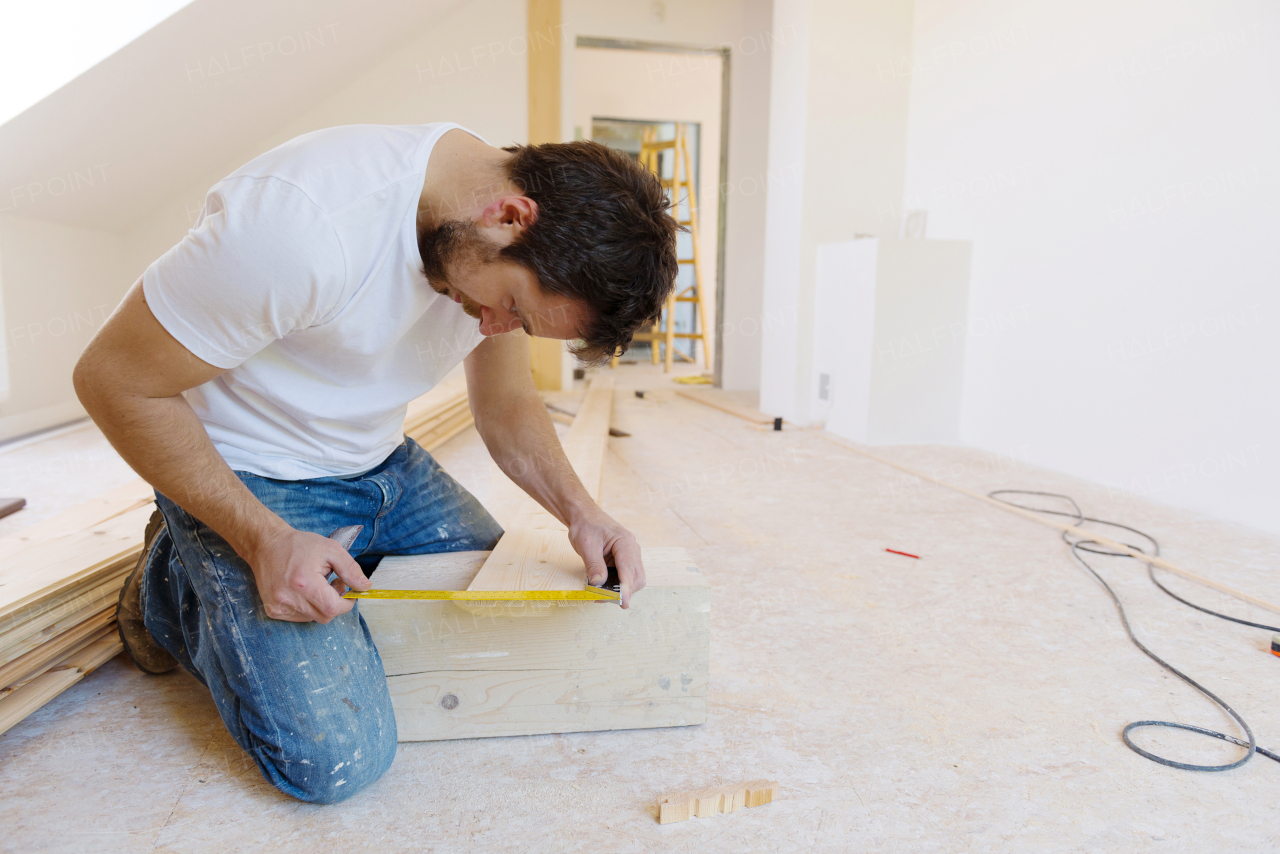 Young handy man working in his new house.