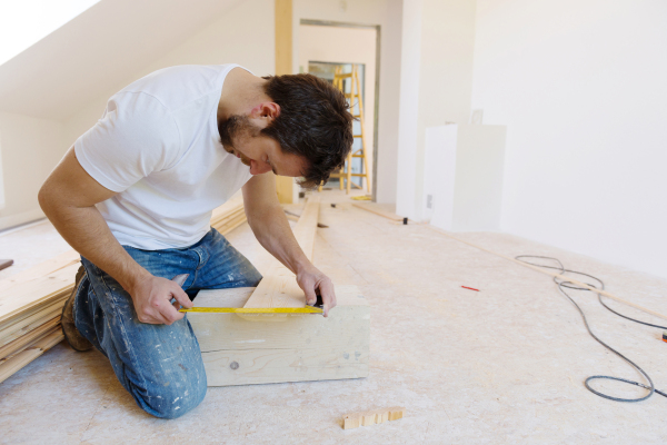 Young handy man working in his new house.