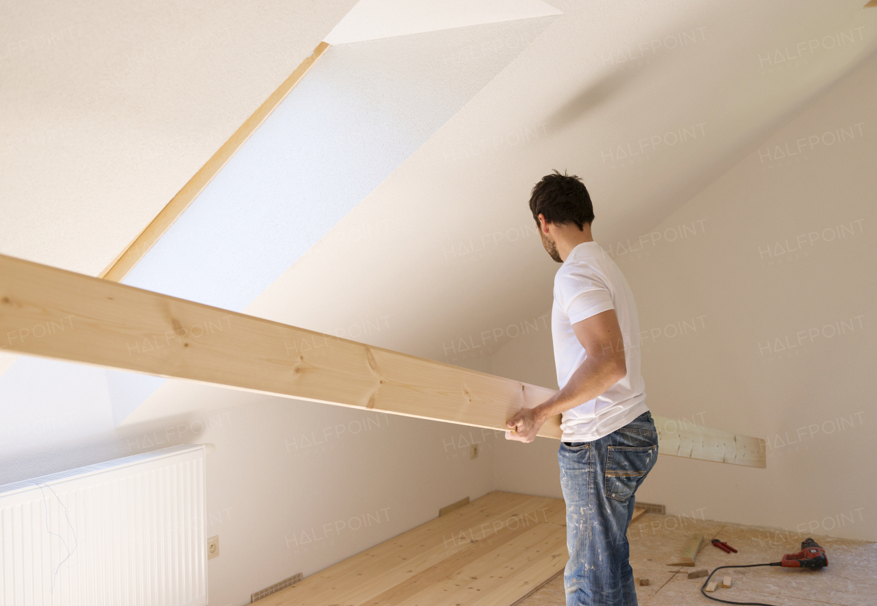 Young handy man working in his new house.