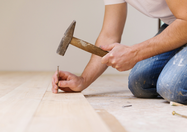 Young handy man working in his new house.