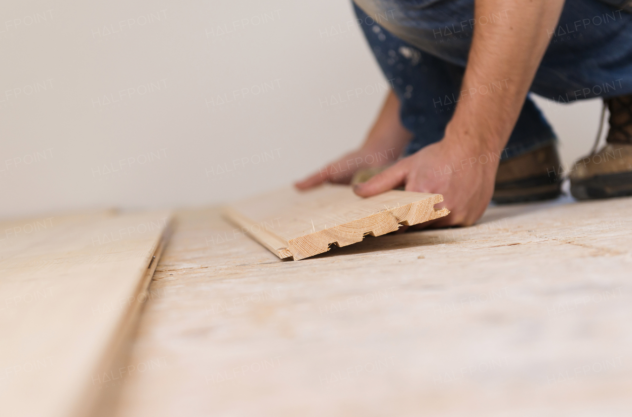 Young handy man working in his new house.