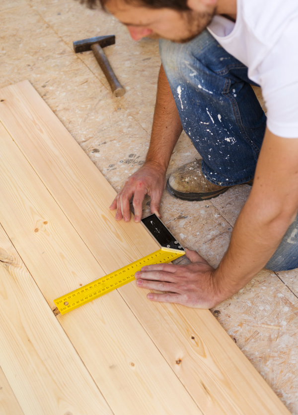 Young handy man working in his new house.