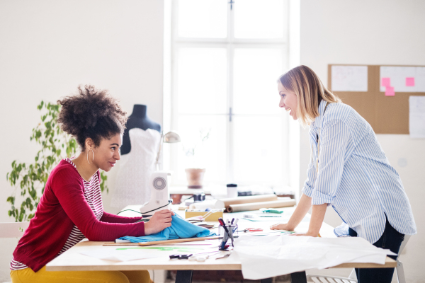 Young creative women working in a studio, startup business.