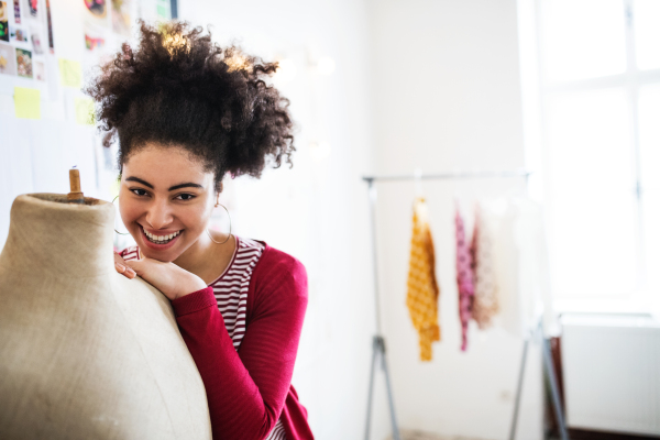 Portrait of young creative woman in a studio, startup business.