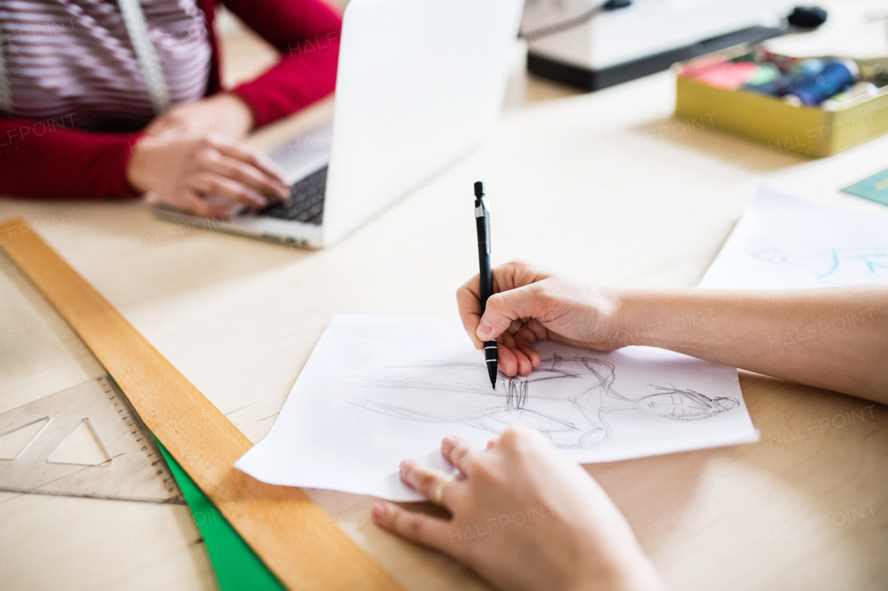 Unrecognizable young creative women working in a studio, startup business.