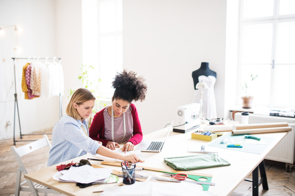 Young creative women working in a studio, startup business.