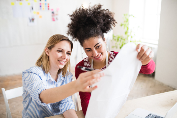 Young creative women working in a studio, startup business.