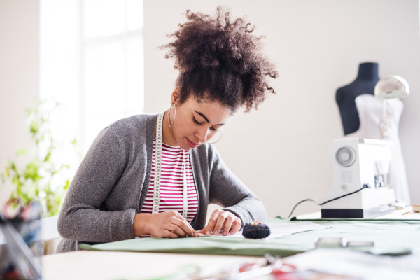 Young creative woman working in a studio, startup business.