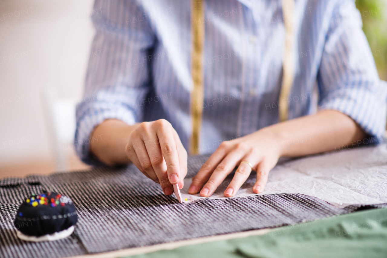 Unrecognizable young creative woman working in a studio, startup business.