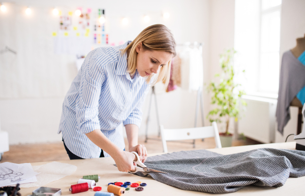 Beautiful young creative woman working in a studio, startup business.