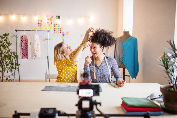 Young creative women in a studio, having fun. Startup business.