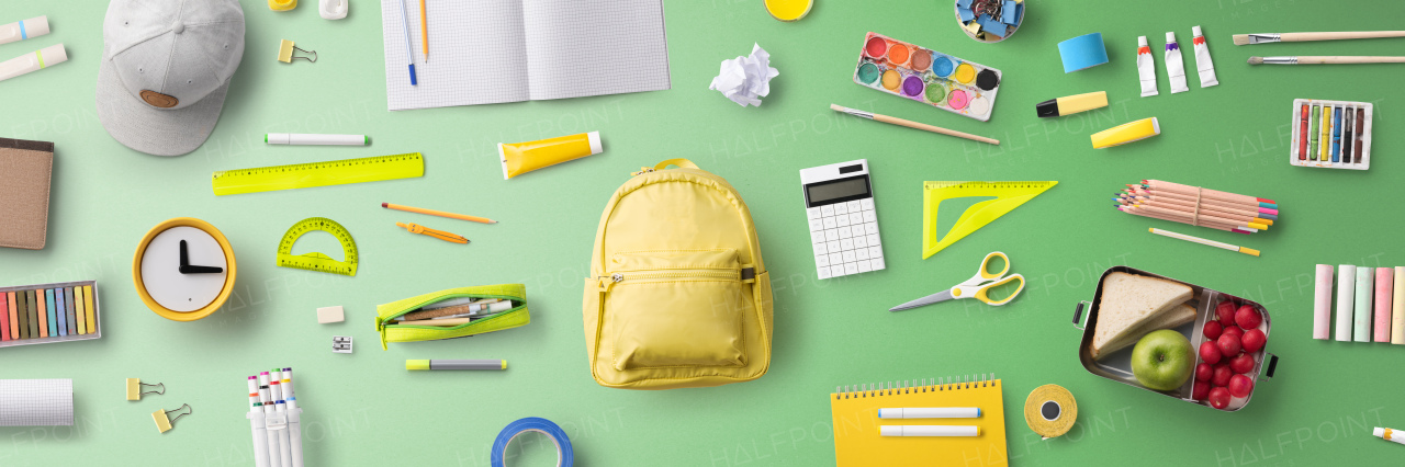 Flat lay top view of face mask, respirator and school supplies, back to school and coronavirus concept.