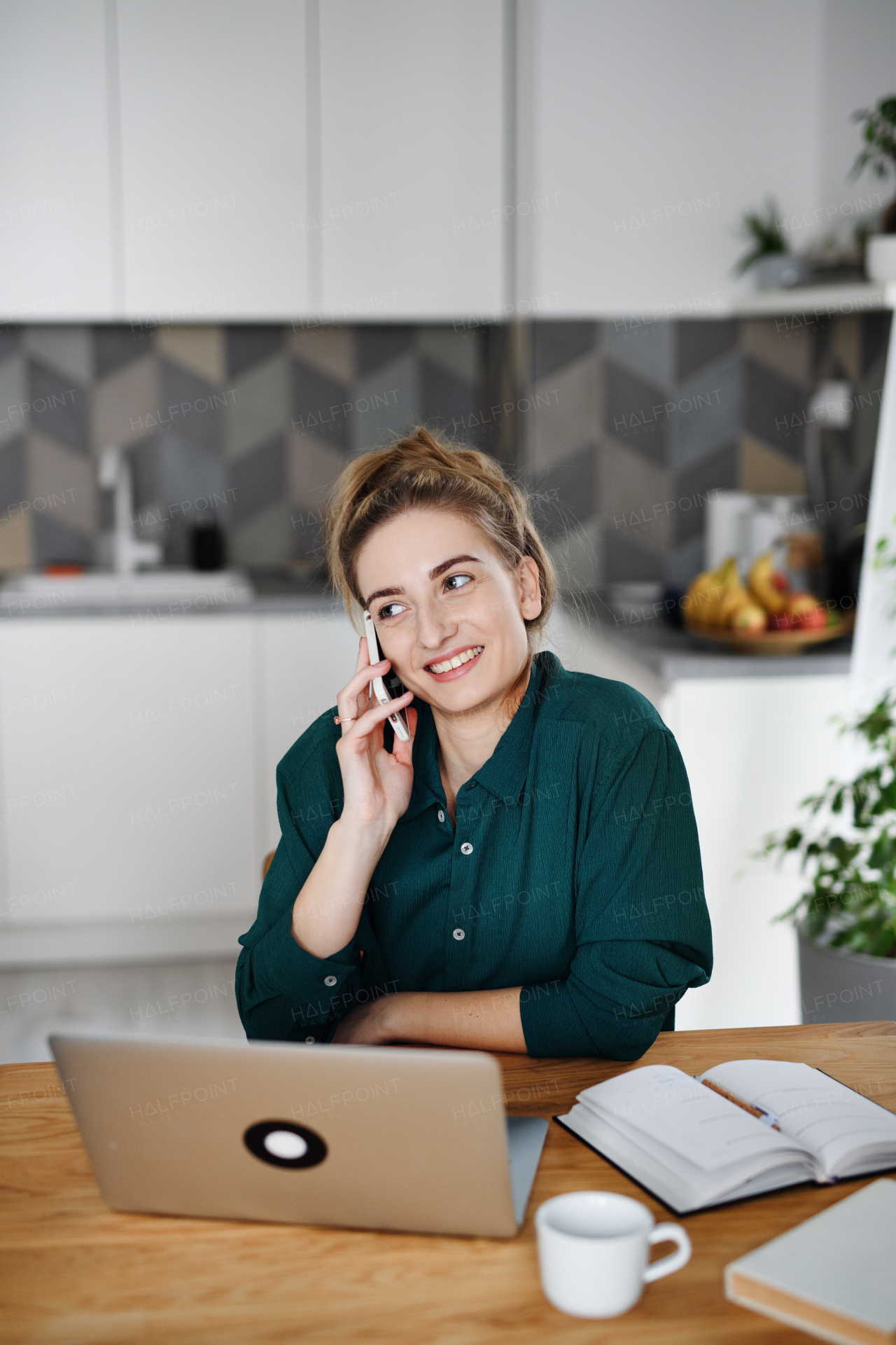 A young woman student with laptop and smartphone at home, home office and learning.