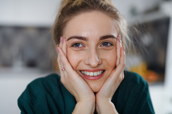 A portrait of young woman student smiling and looking at camera.