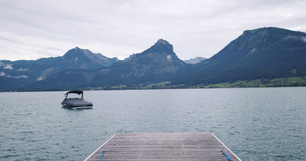 Potrait of pier by lake in mountains.