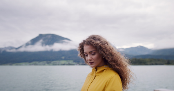 Portrait of young woman tourist on a hiking trip in nature, standing.