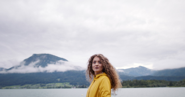 Portrait of young woman tourist on a hiking trip in nature, standing.