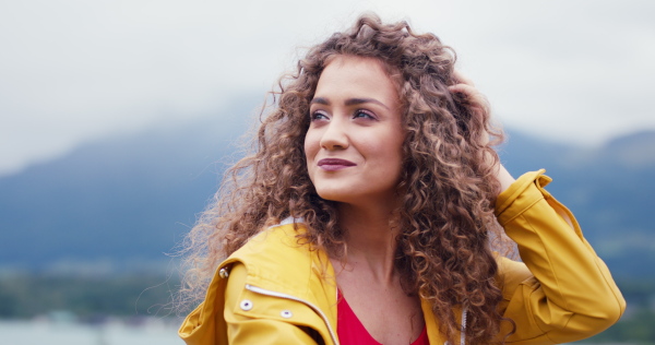 Portrait of young woman tourist on a hiking trip in nature, standing.