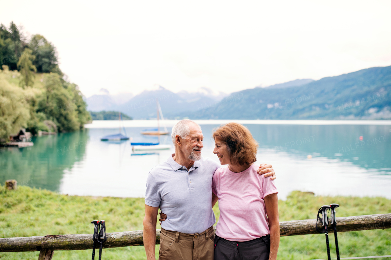 A senior pensioner couple hikers standing in nature, resting. Copy space.