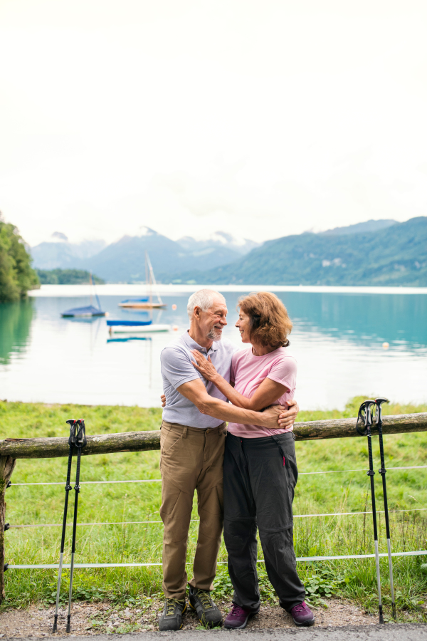 A senior pensioner couple hikers standing in nature, resting. Copy space.