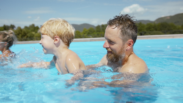 A beautiful family having fun together in the pool.