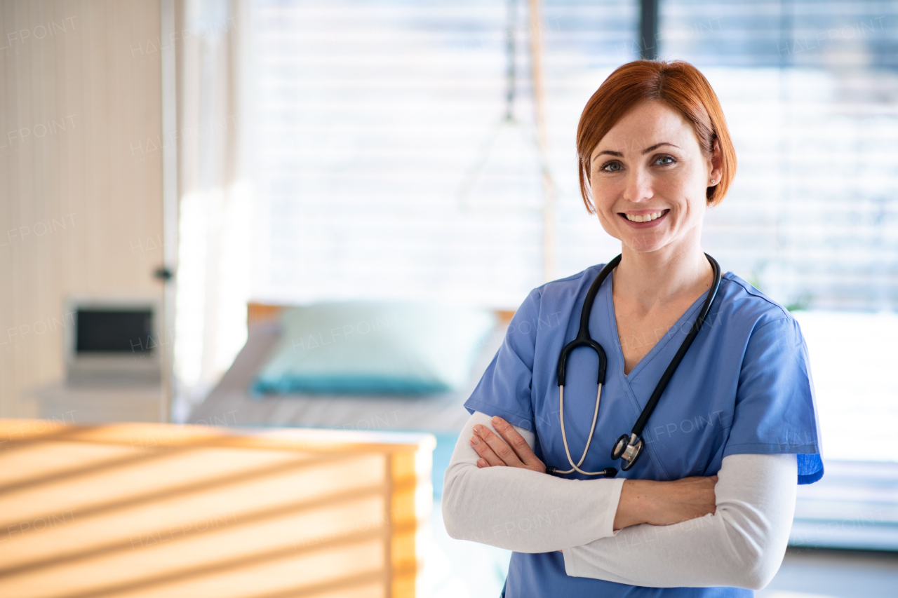 Portrait of female doctor or nurse standing in hospital room. Copy space.