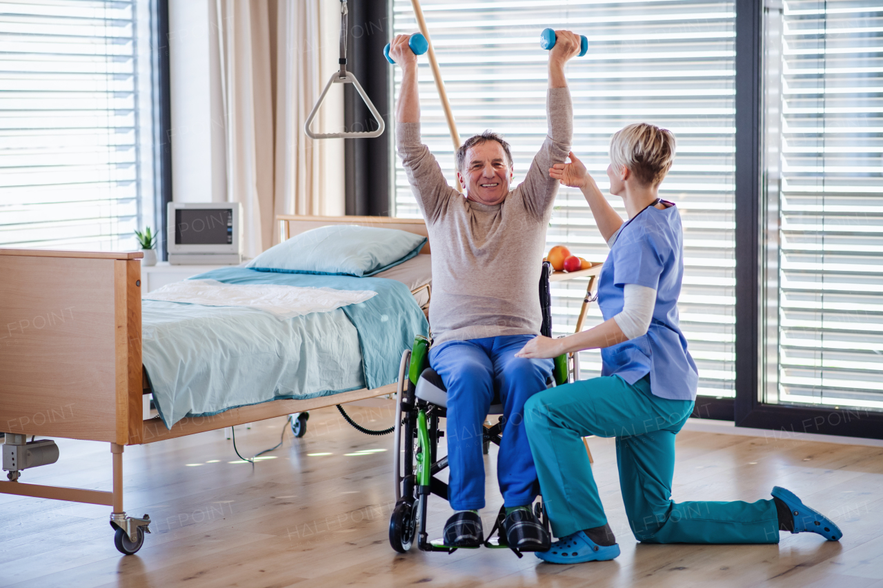 A healthcare worker and senior patient in hospital, physiotherapy concept.