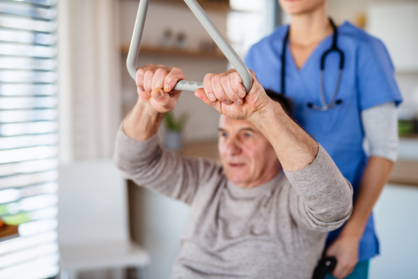 A healthcare worker and senior patient in hospital, physiotherapy concept.