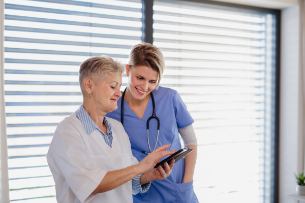 Healthcare workerstalking indoors, using smartphone. Copy space.