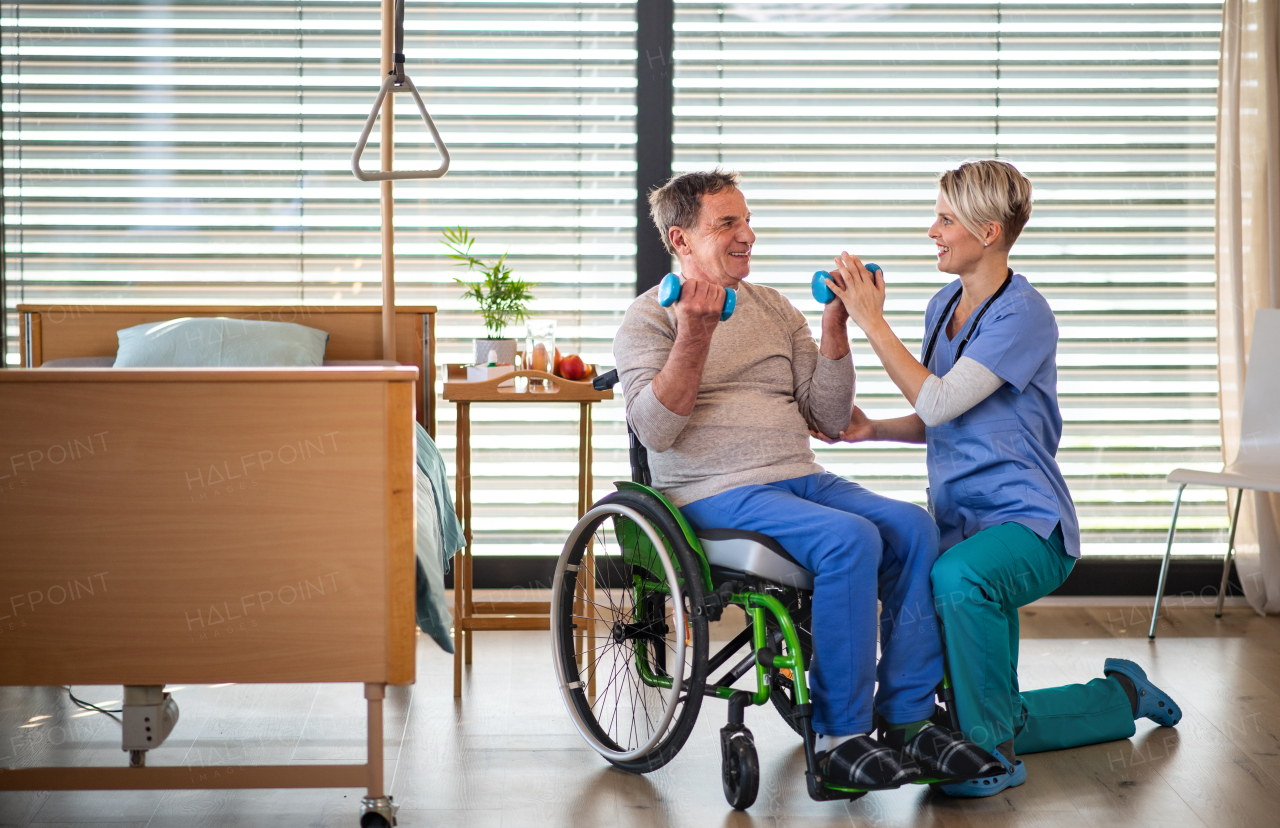 A healthcare worker and senior patient in hospital, physiotherapy concept.