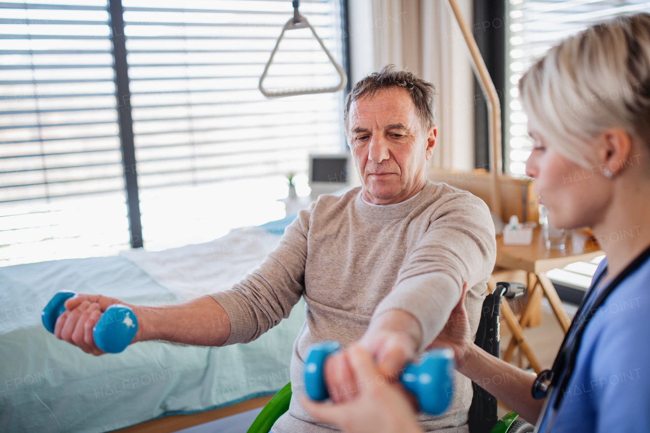 A healthcare worker and senior patient in hospital, physiotherapy concept.