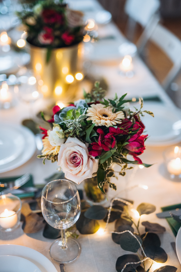 A table set for a meal indoors in a room on a party, a wedding or family celebration.