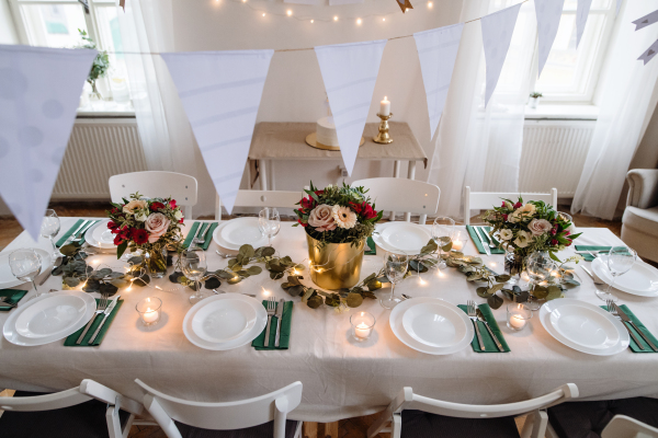 A top view of table set for a meal indoors in a room on a party, a wedding or family celebration.