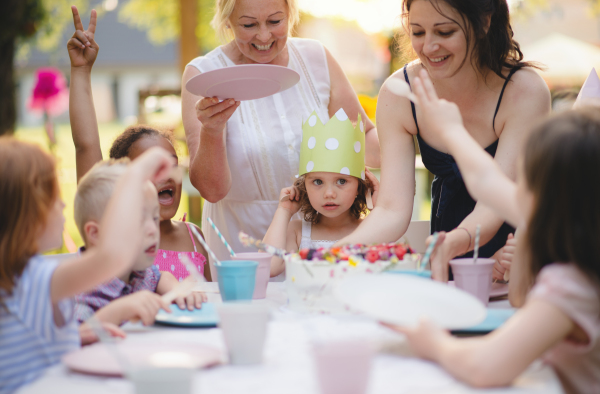 Kids birthday party outdoors in garden in summer, a celebration concept.