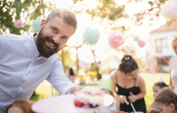 Birthday party outdoors in garden in summer, a celebration concept.