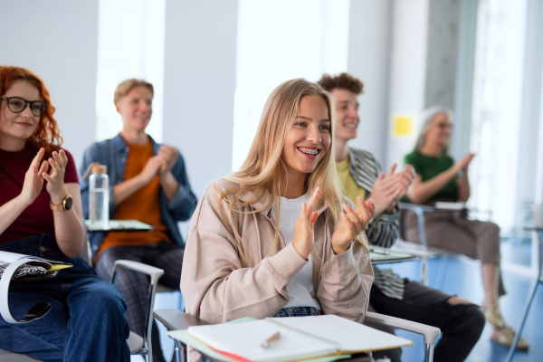 A portrait of group of university students sitting in classroom indoors, studying