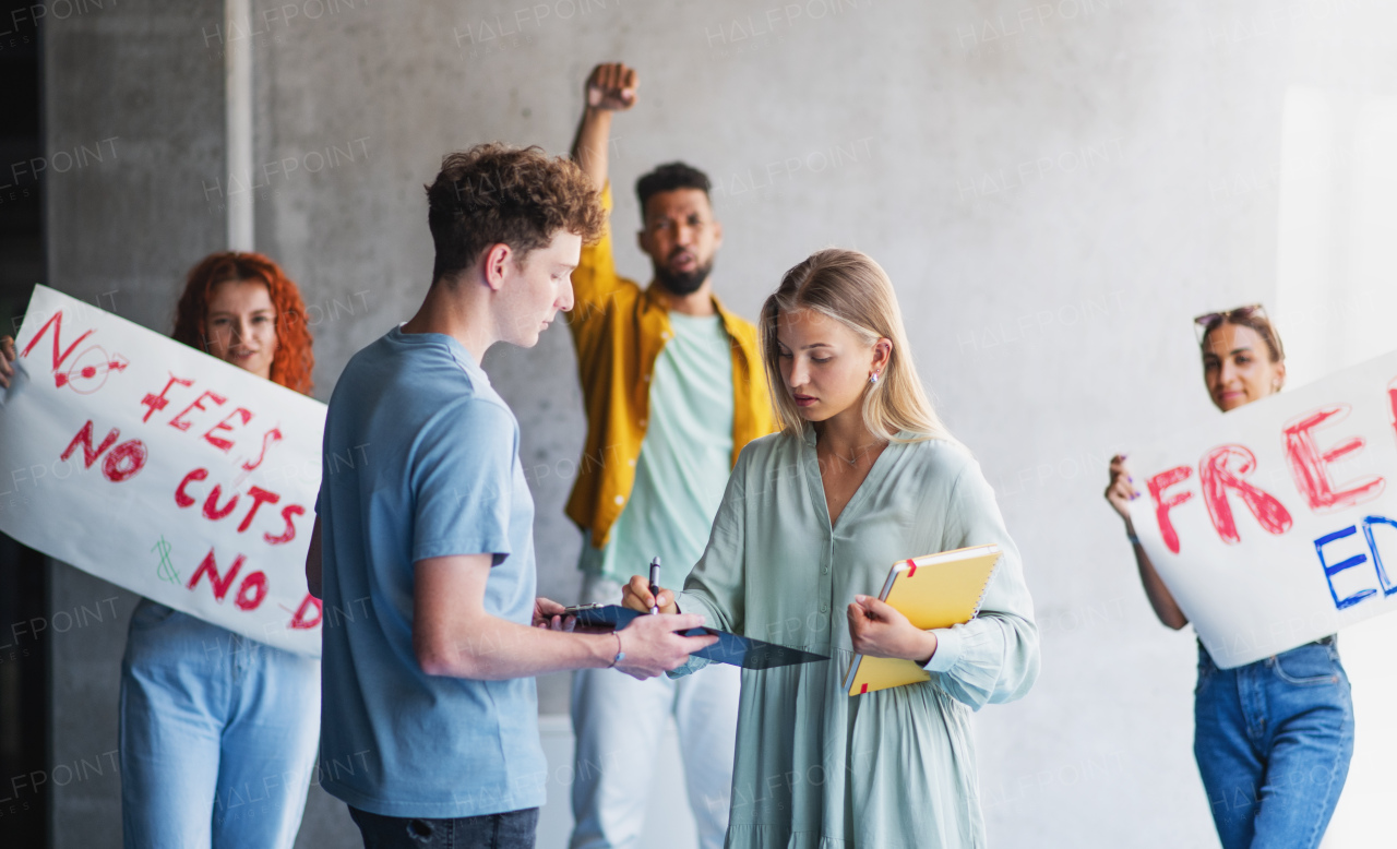 University students activists protesting indoors at school, fighting for free education concept.