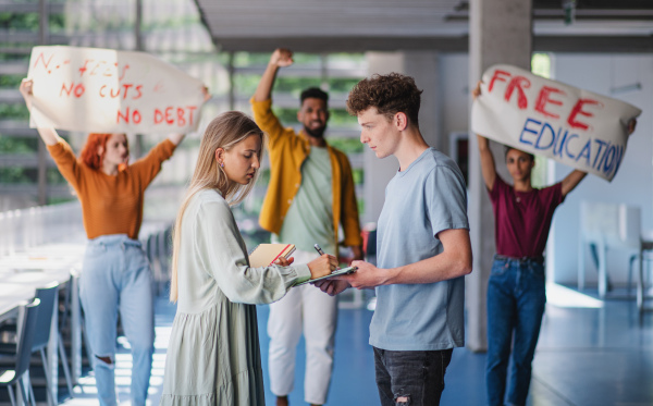 University students activists protesting indoors at school, fighting for free education concept.