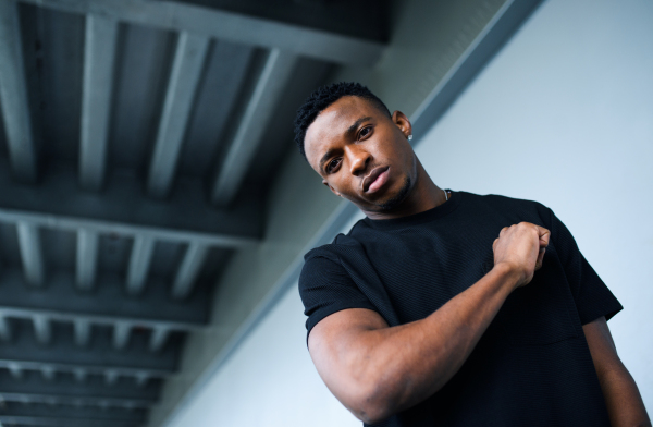 Portrait of black man with respect gesture outdoors in city, black lives matter concept.