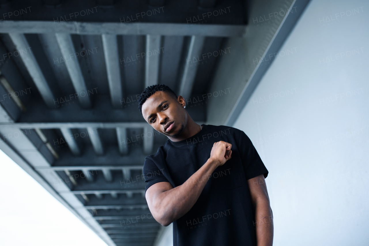 Portrait of black man with respect gesture outdoors in city, black lives matter concept.