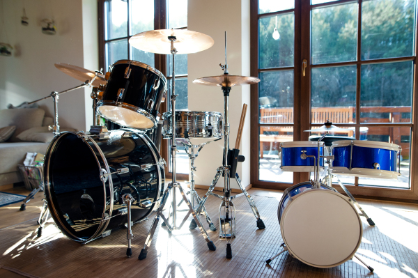 Set of drums indoors in living room in a house, playing musical instrument concept.