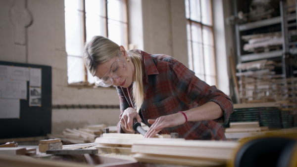 A female carpenter working on her product. Small business concept.