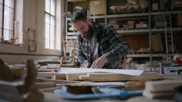 A male carpenter working on his product. Small business concept.