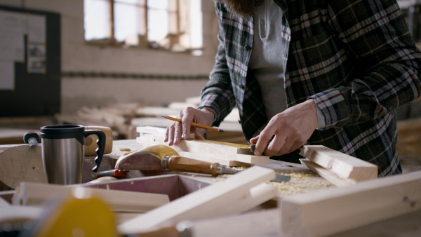 A close up of male carpenter working on his product. Small business concept.