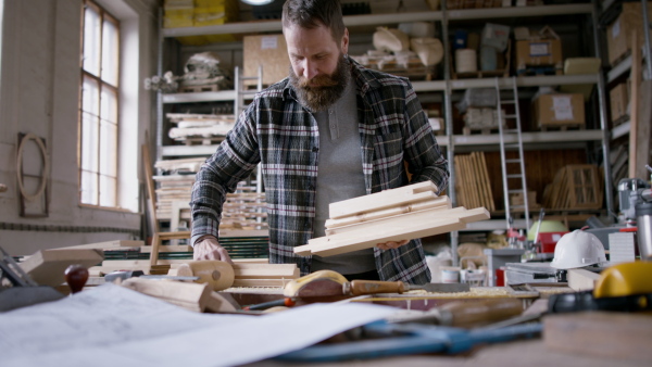 A male carpenter working on his product. Small business concept.