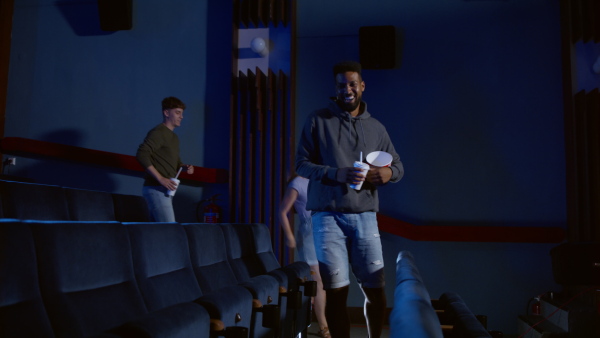 A cheerful group of friends getting ready for movie in the cinema.