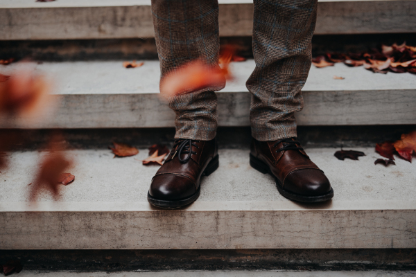 Close-up of mens legs at a city staircase.