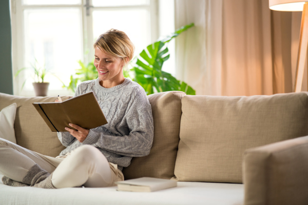 Portrait of woman relaxing indoors at home, mental health care concept. Copy space.