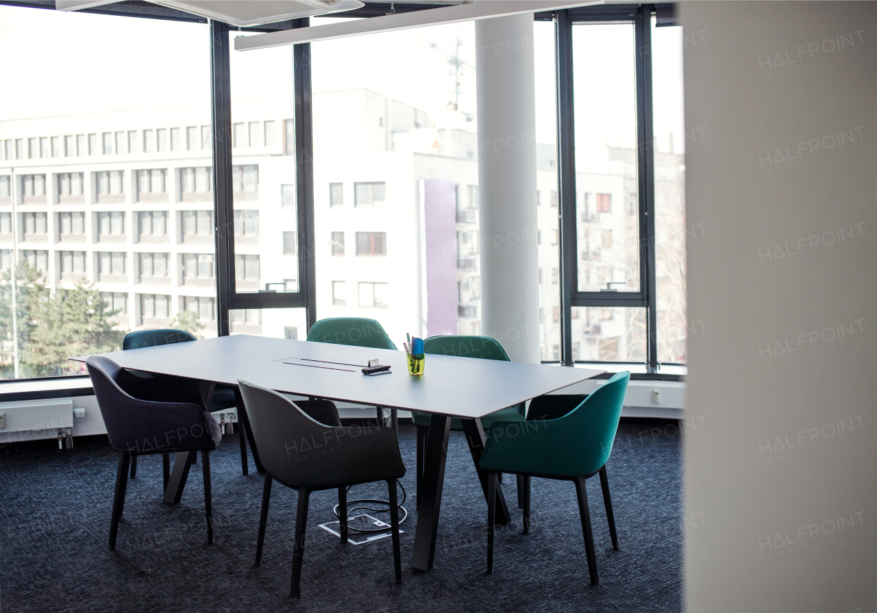 A large table with chairs in boardroom, an interior of office building.